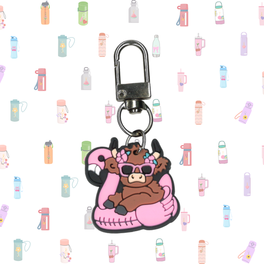 Keychain with cartoon cow design on a patterned background