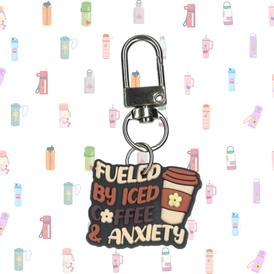 Keychain with 'Fueled by Iced Coffee & Anxiety' text on a patterned background